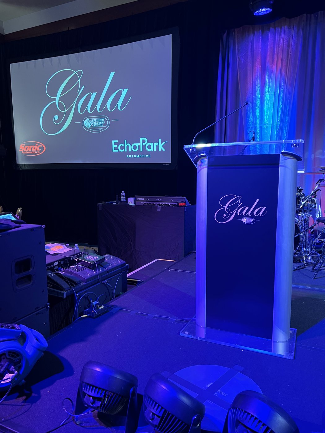 Gala podium and screen on a blue-lit stage