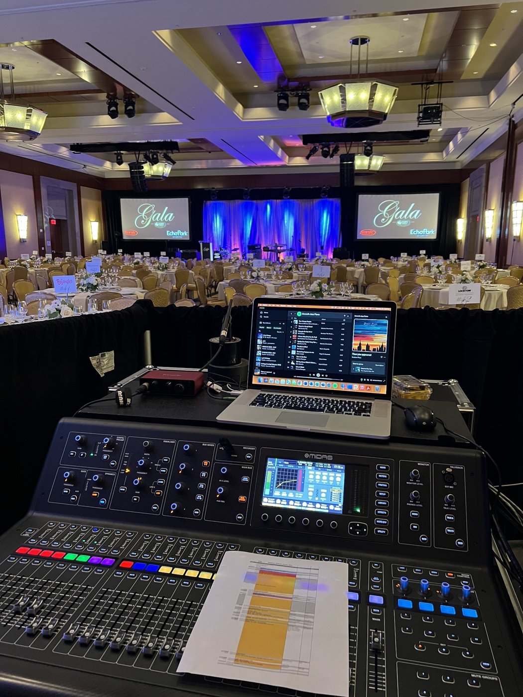 Audio console and laptop at the front-of-house position facing the gala ballroom and stage