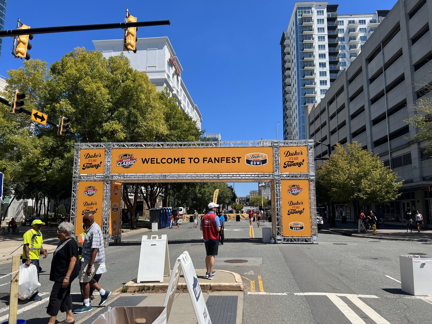 The Welcome to FanFest truss entrance arch with Duke's Mayo Classic banners across a closed city street